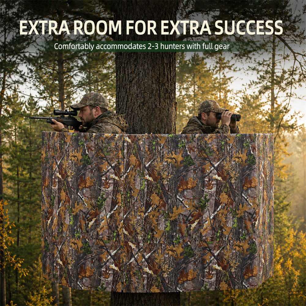 A large camouflage tree-view hunting blind set up on a tree in a forest, with two hunters partially visible inside looking out. White text at the top reads 'EXTRA ROOM FOR EXTRA SUCCESS' and 'Comfortably accommodates 2-3 hunters with full gear'.