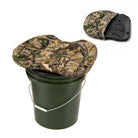 A camouflage-patterned bucket seat cushion shown resting on a dark green plastic bucket, with a smaller inset view in the upper right showing the underside of the cushion.