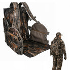 A large camouflage backpack shown open with a matching pouch and a padded insert, alongside a small inset of a person wearing the same camouflage outfit. The main product is the backpack system, photographed on a plain white background.